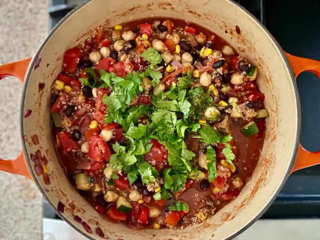 overhead view of chili with cilantro, zest, and lime juice added