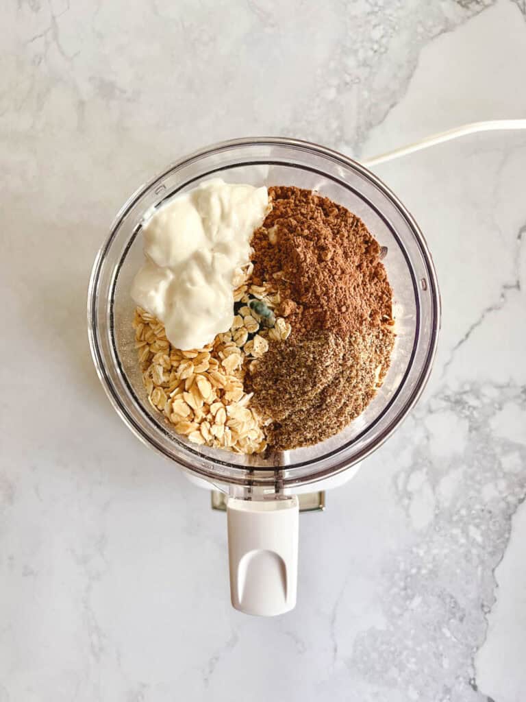 food processor with ingredients for creamy cocoa overnight oats