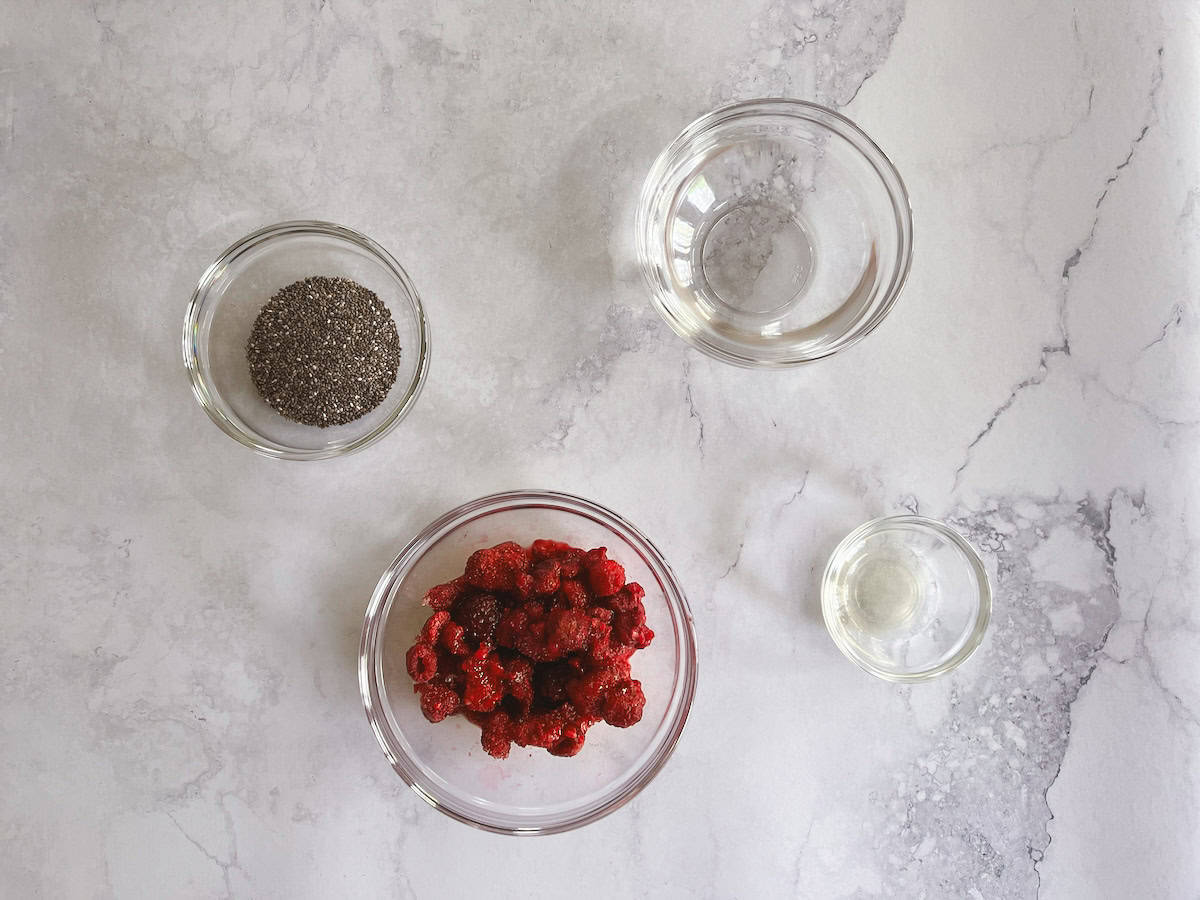 bowls containing ingredients for raspberry chia pudding