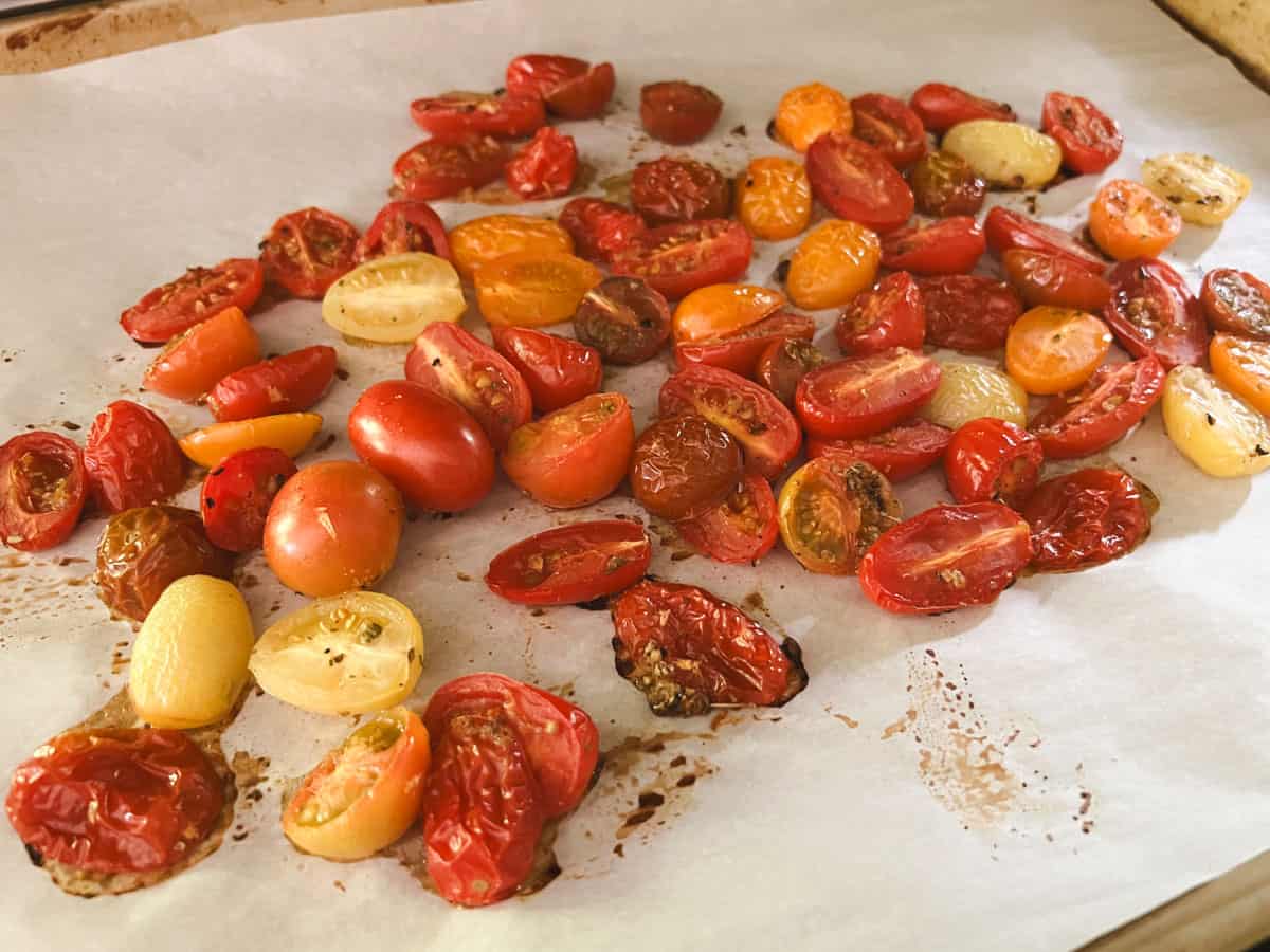 blistered tomatoes on a baking sheet