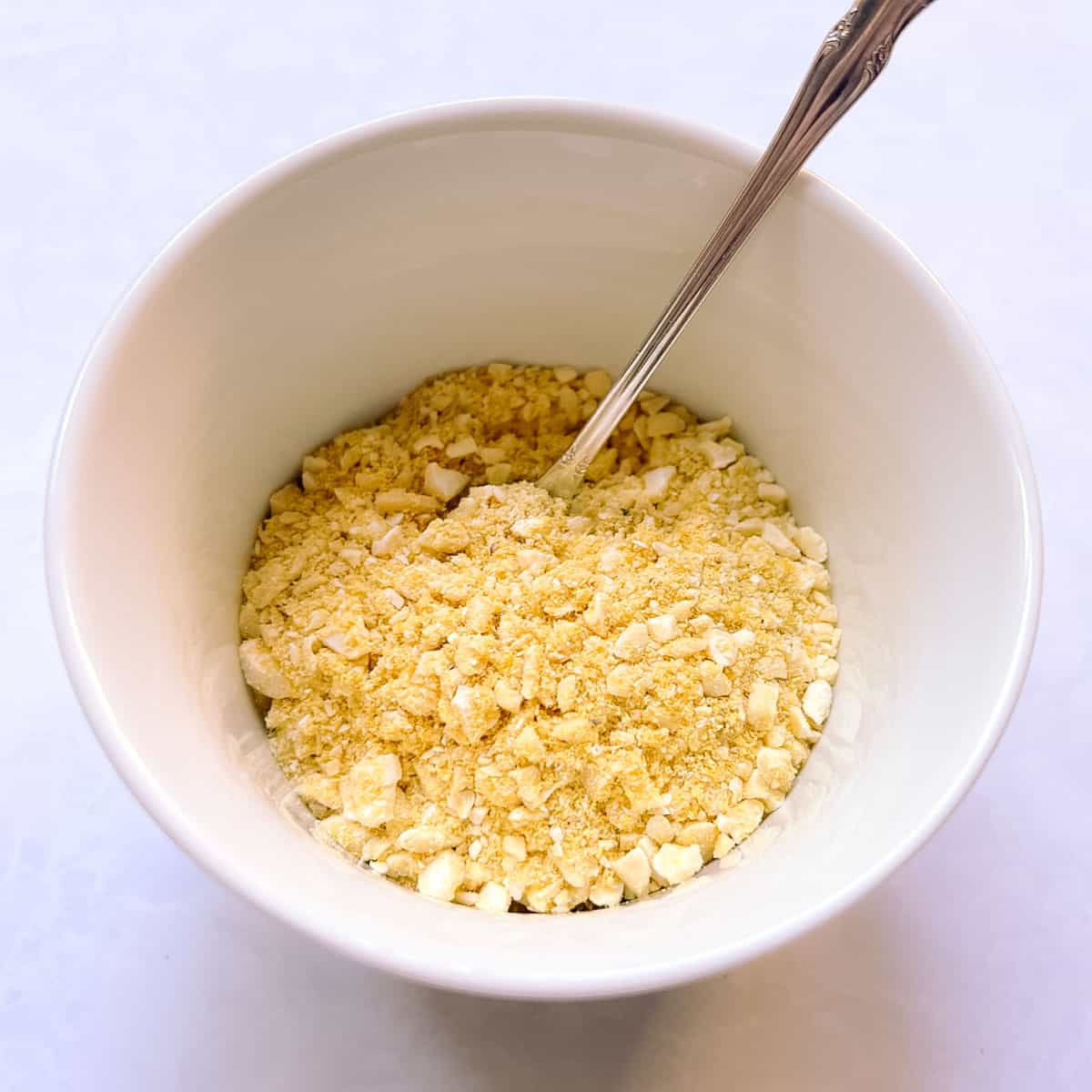 bowl of quick vegan Parmesan with serving spoon