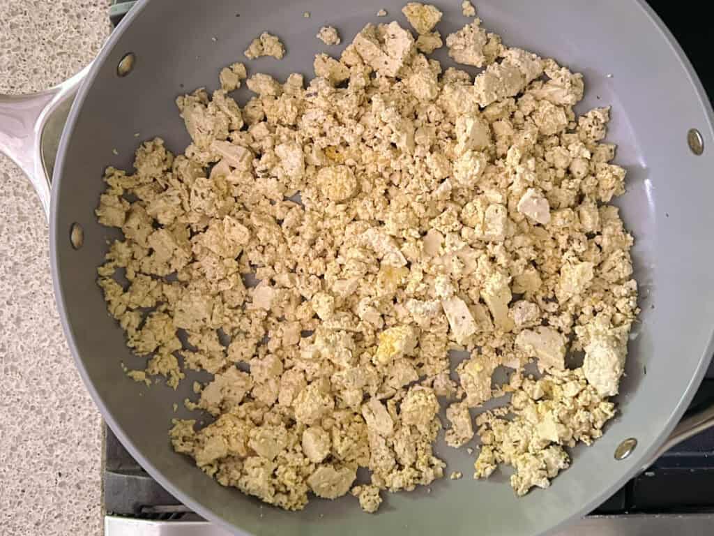 herbed tofu scramble in a large skillet on a stove