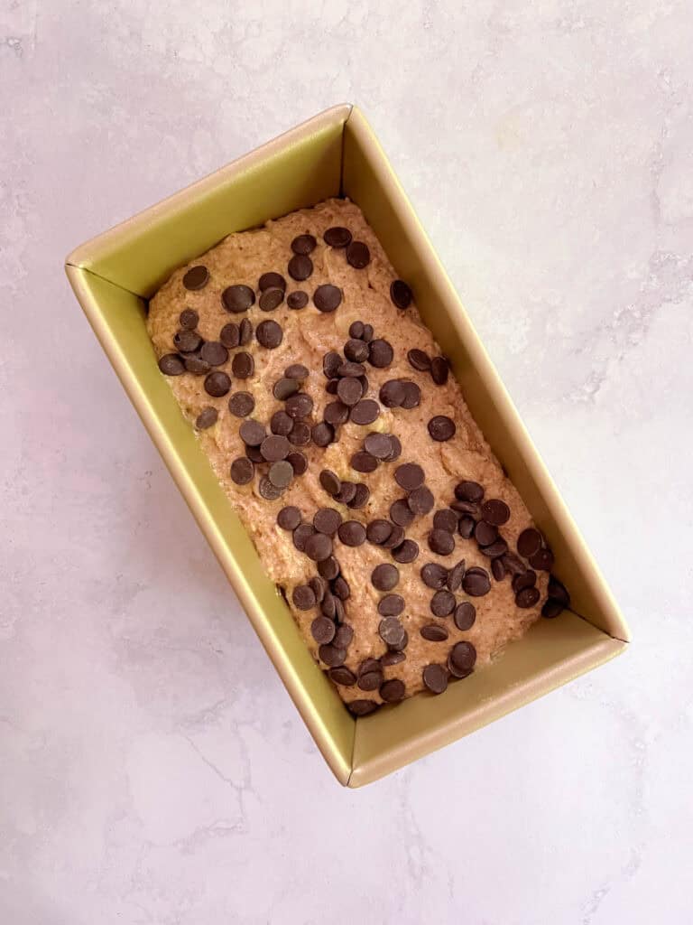 overhead view of loaf pan containing oil-free perfect banana bread topped with chocolate sprinkles