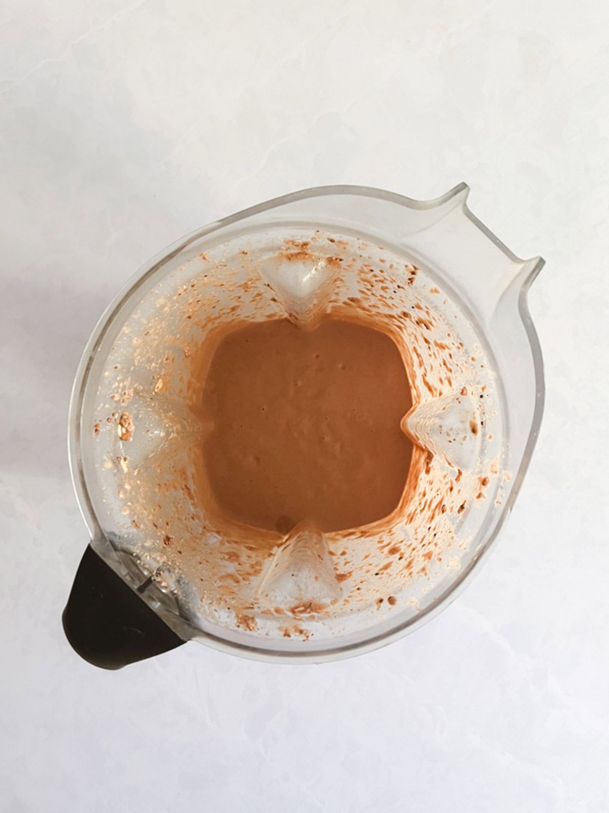 blended ingredients for creamy blended chocolate peanut butter overnight oats in a blender