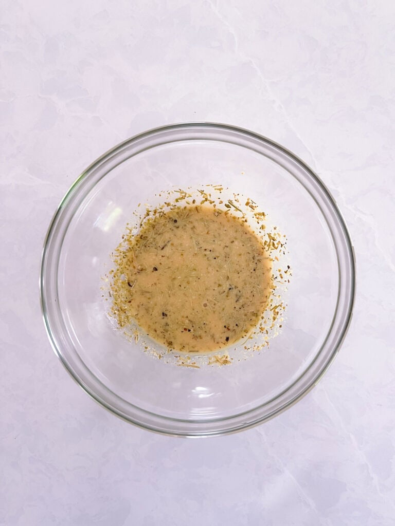 bowl containing oil-free dressing for Mediterranean salad