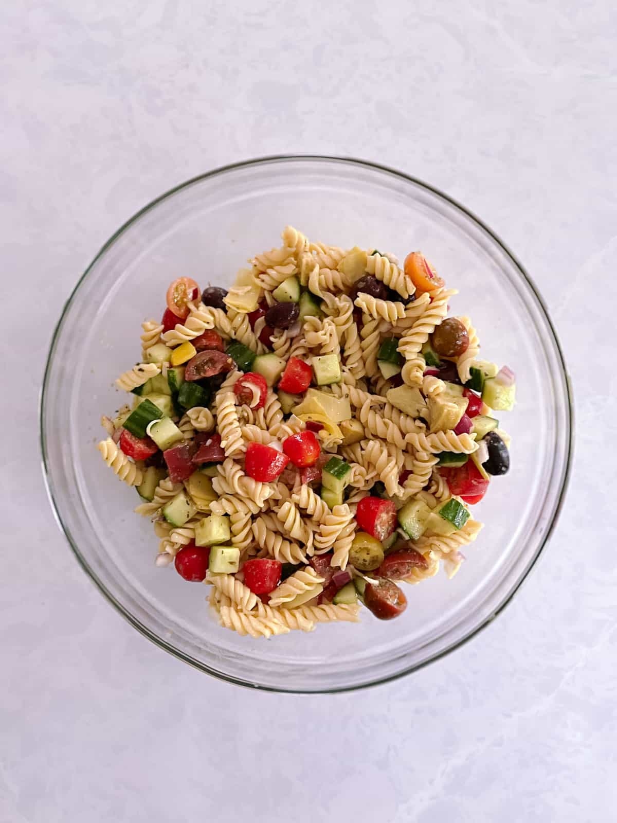 bowl of mixed salad ingredients with pasta added