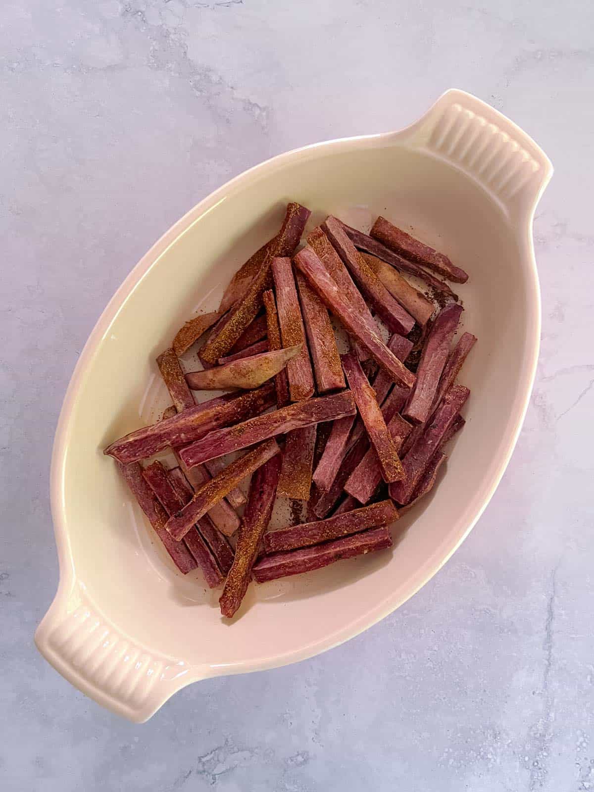 oval serving dish holding Tex-Mex seasoned purple sweet potato fries