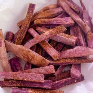 close up of Tex-Mex seasoned purple sweet potato fries on parchment paper