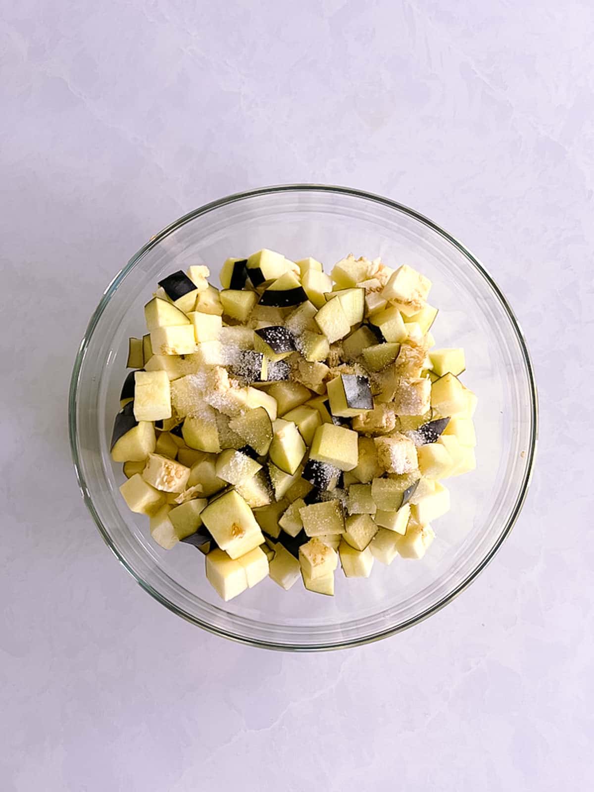 glass bowl of diced and salted eggplant