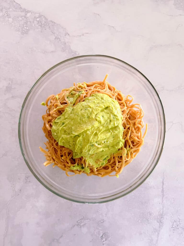 cooked linguine with avocado basil sauce on top