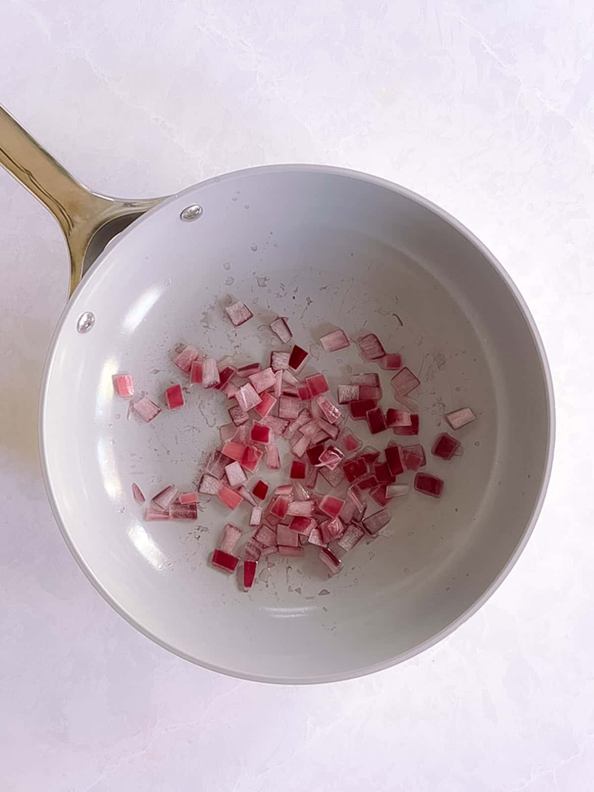 skillet containing cooked diced red onion