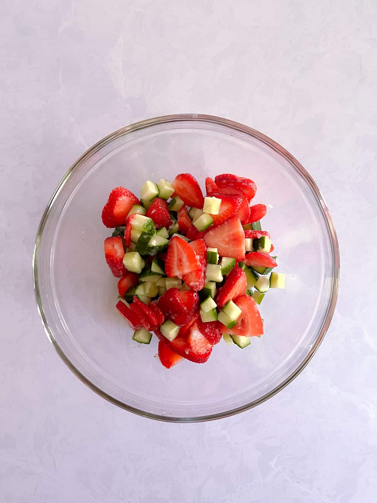 bowl of strawberries and cucumbers mixed with champagne vinaigrette