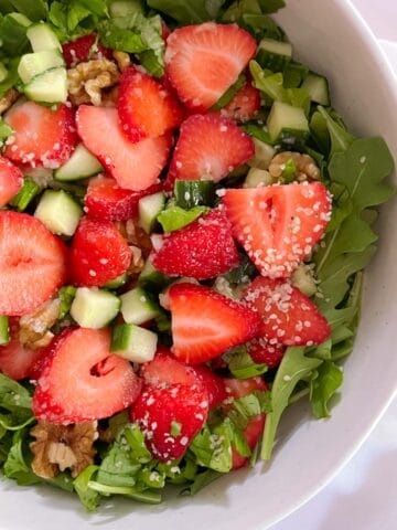 close up of bowl of strawberry basil salad with champagne vinaigrette