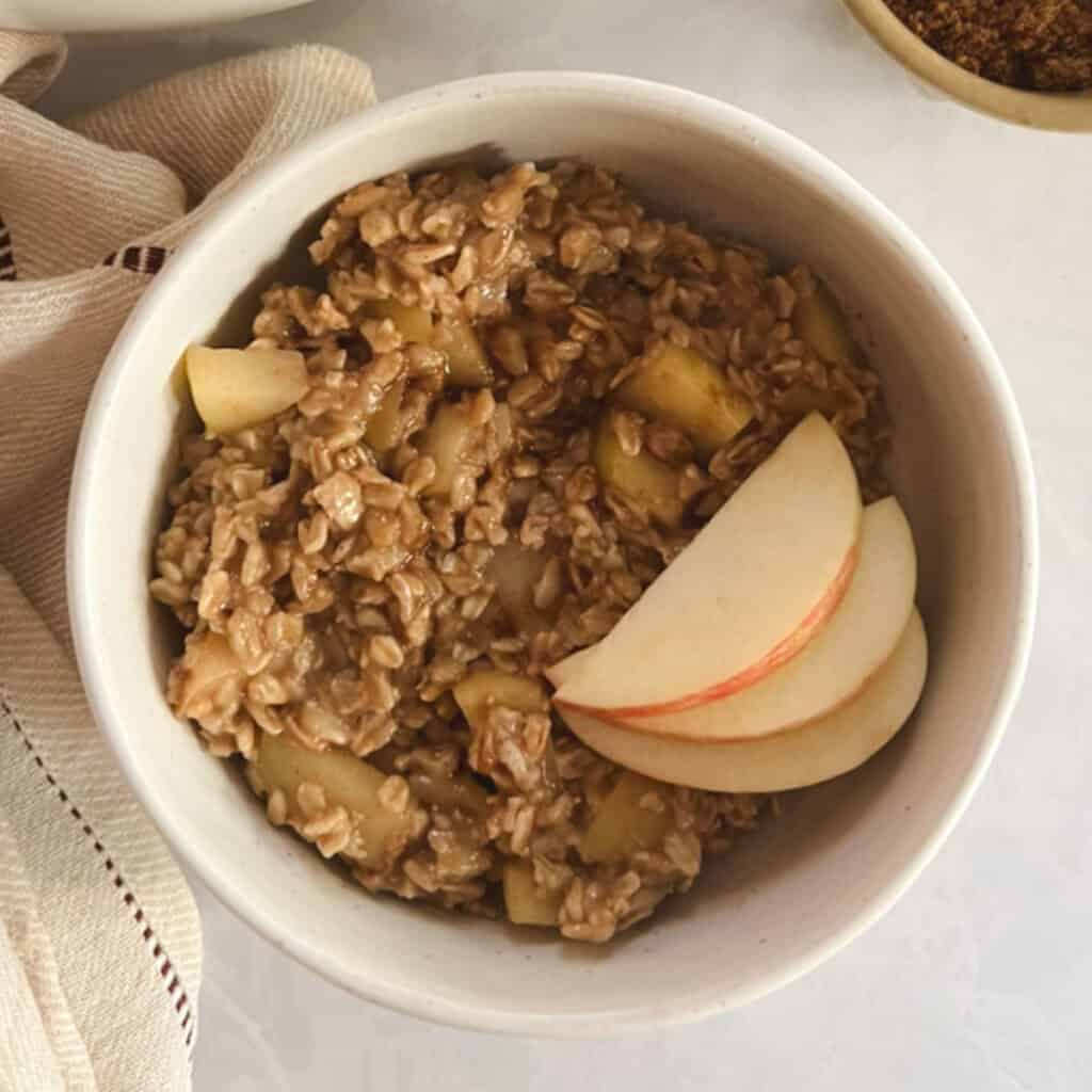bowl of one-pot apple cinnamon oatmeal garnished with apple slices