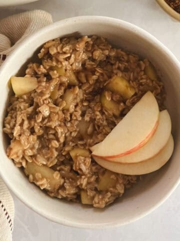 bowl of one-pot apple cinnamon oatmeal garnished with apple slices