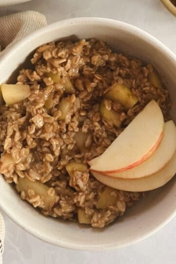 bowl of one-pot apple cinnamon oatmeal garnished with apple slices