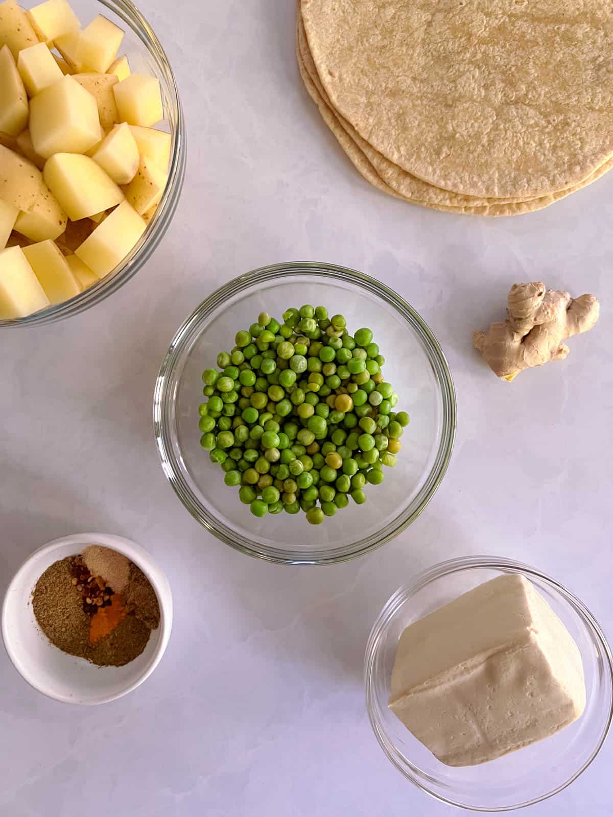 overhead view of ingredients for potato and pea samosa wraps