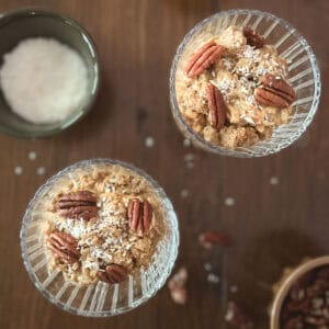 two parfait glasses of pumpkin spice overnight oats (without yogurt) and small bowl of shredded coconut