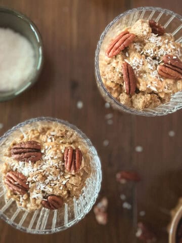 two parfait glasses of pumpkin spice overnight oats (without yogurt) and small bowl of shredded coconut