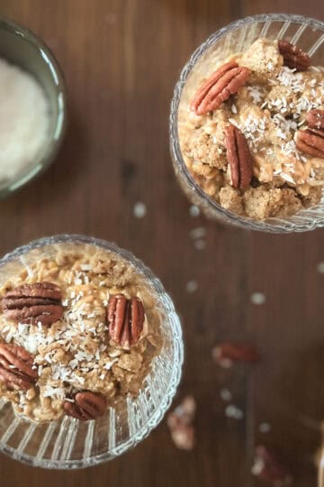 two parfait glasses of pumpkin spice overnight oats (without yogurt) and small bowl of shredded coconut