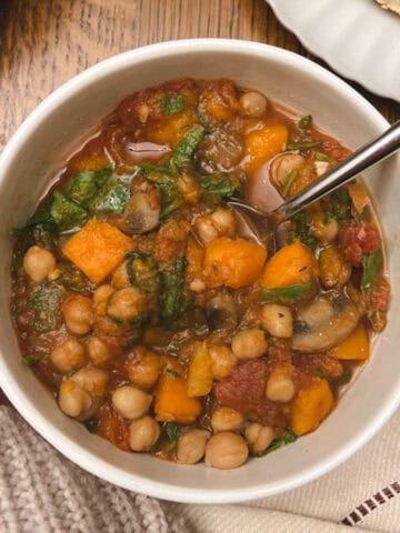 bowl of slow cooker fall harvest ratatouille held in a hand