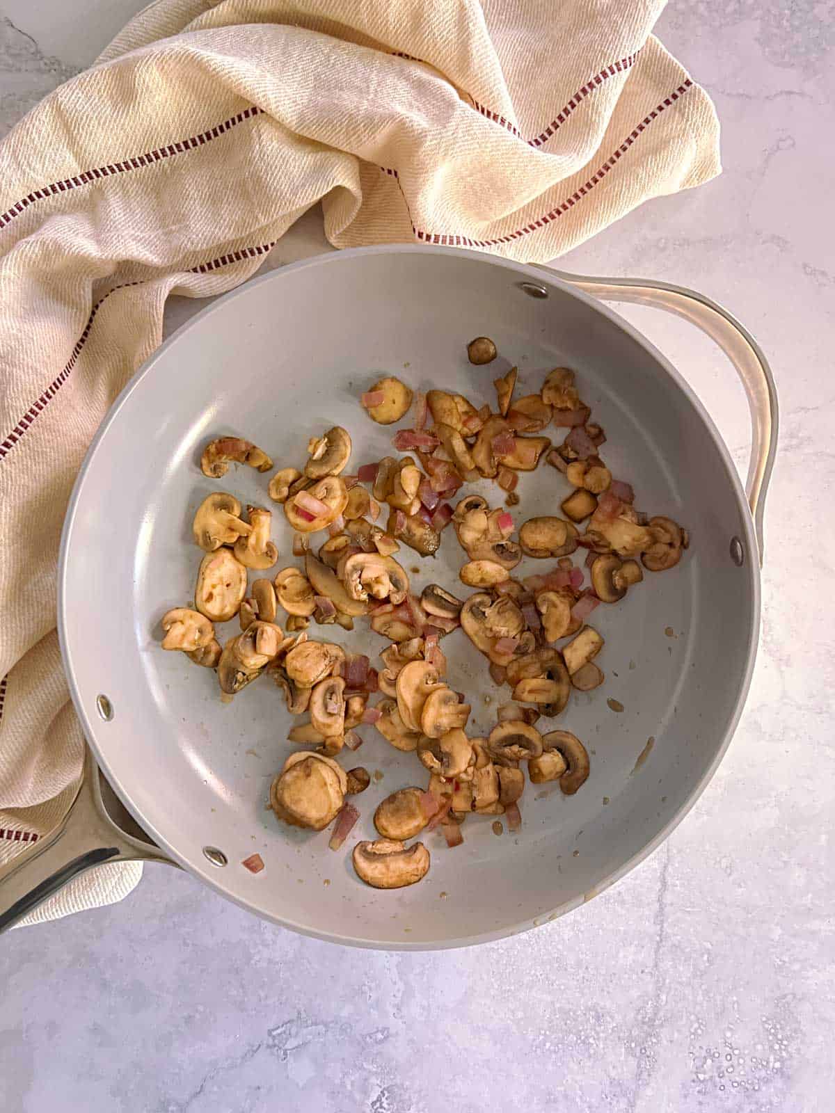 mushrooms and onions cooked in a skillet