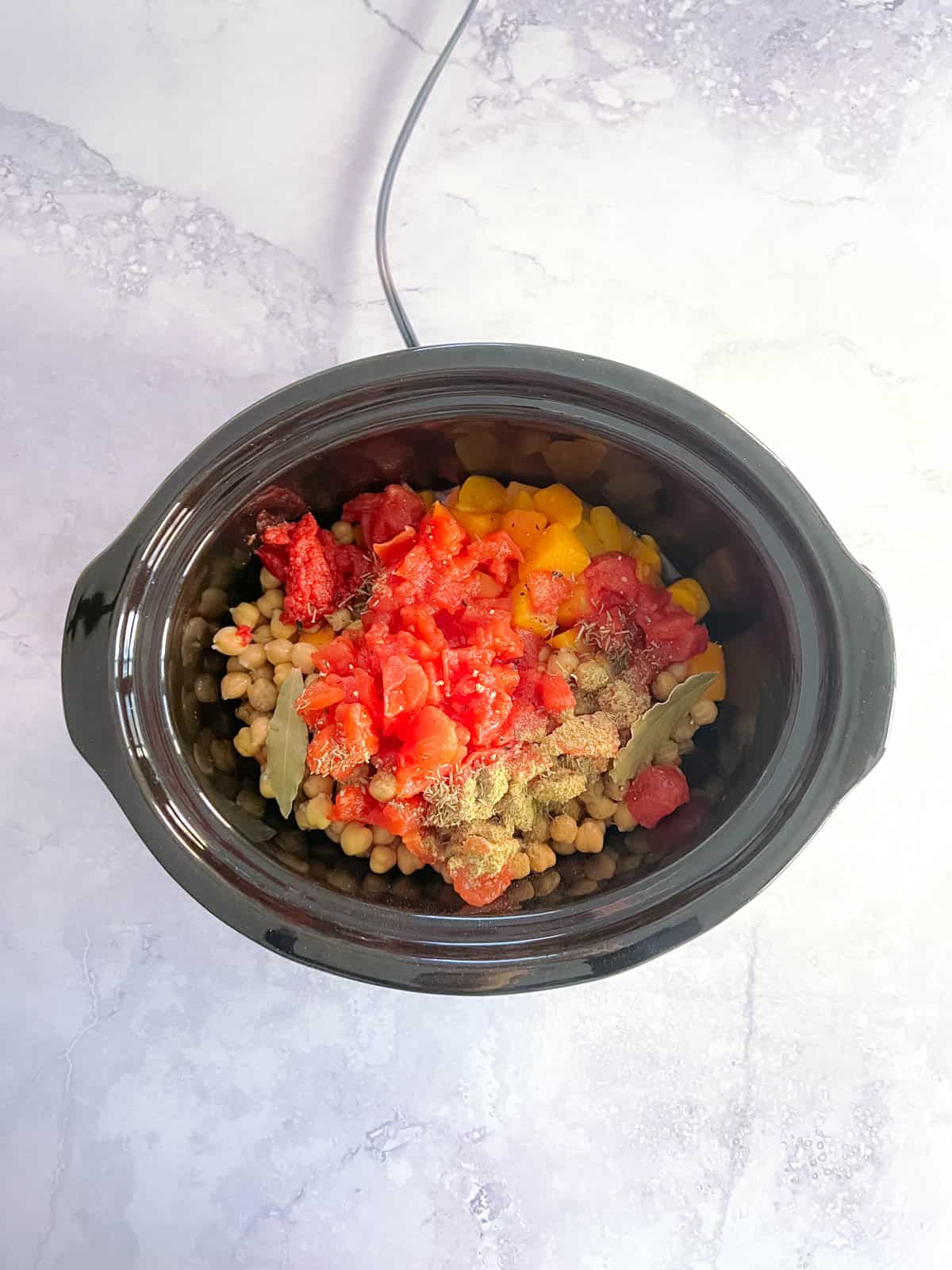 slow cooker containing all ingredients for fall harvest ratatouille