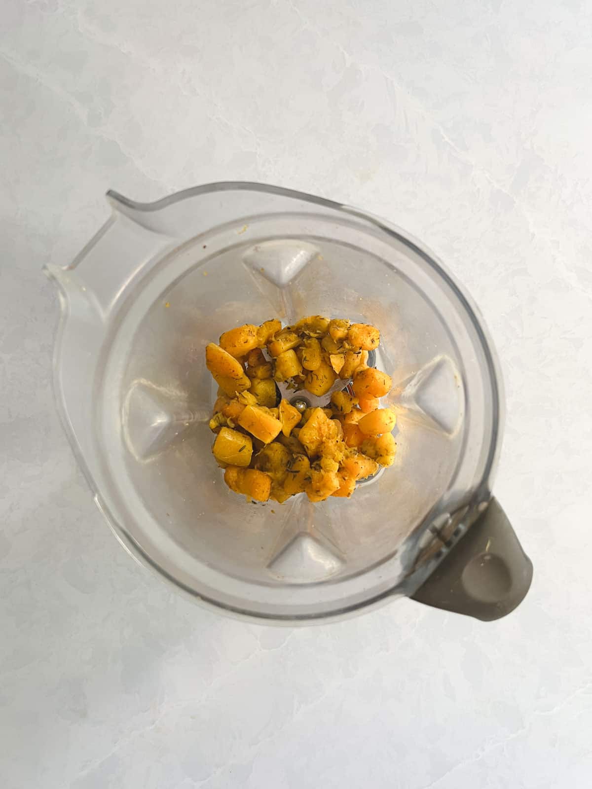 blender containing cooked butternut squash and broth