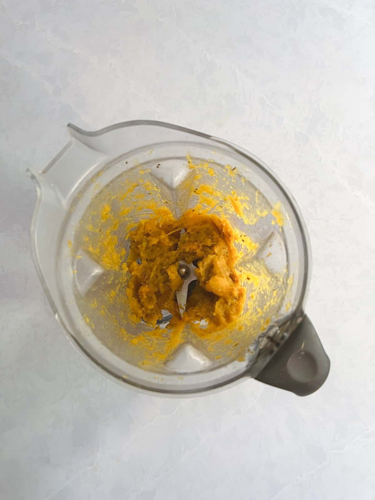 blender containing blended butternut squash and broth mixture