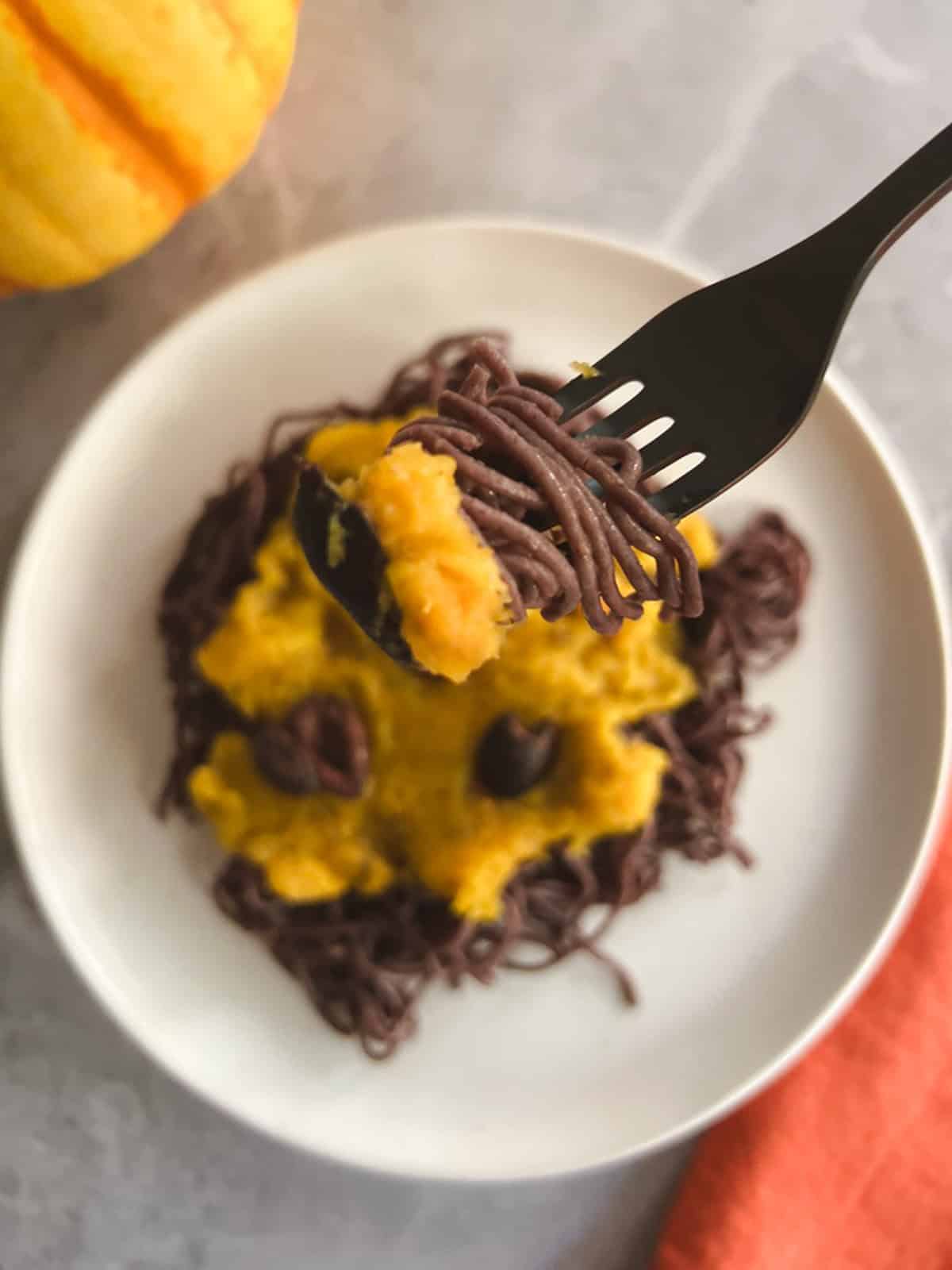 closeup of a fork holding a bite of vegan Halloween pasta