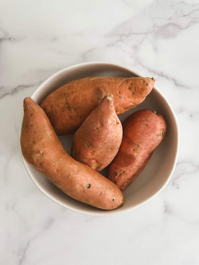 overhead view of a bowl of 4 sweet potatoes