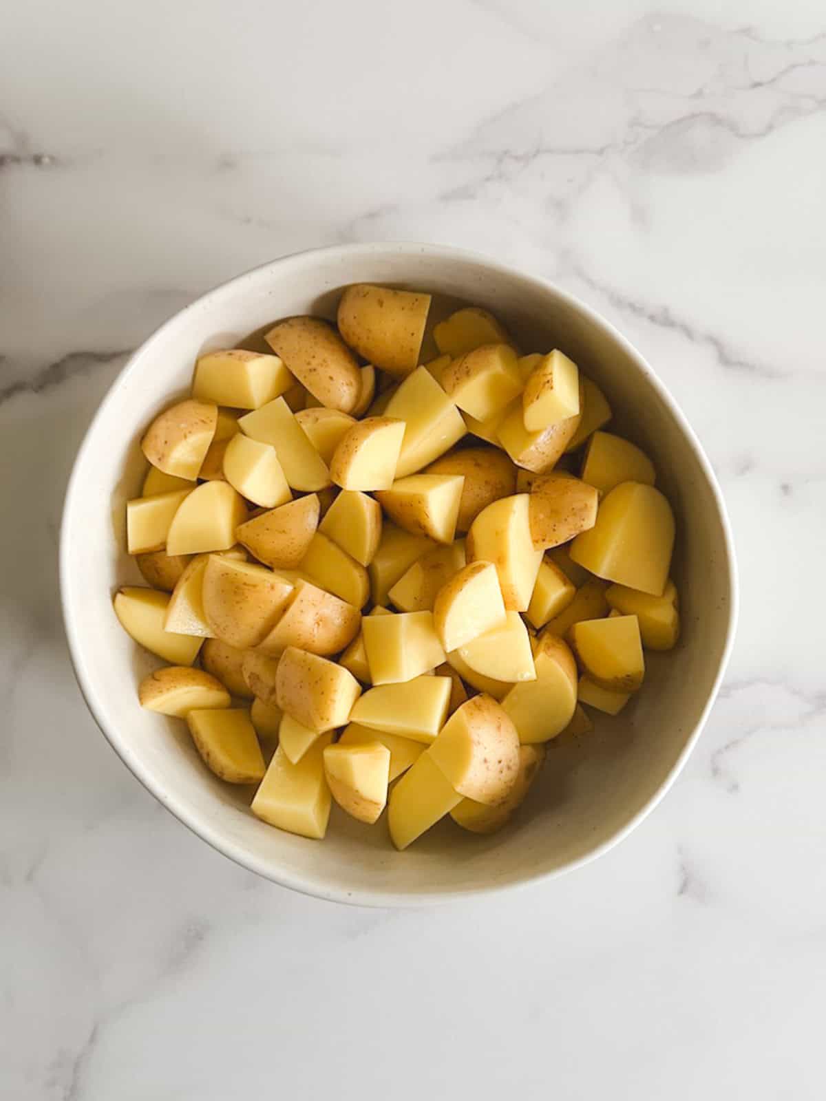 overhead view of bowl of chopped potatoes