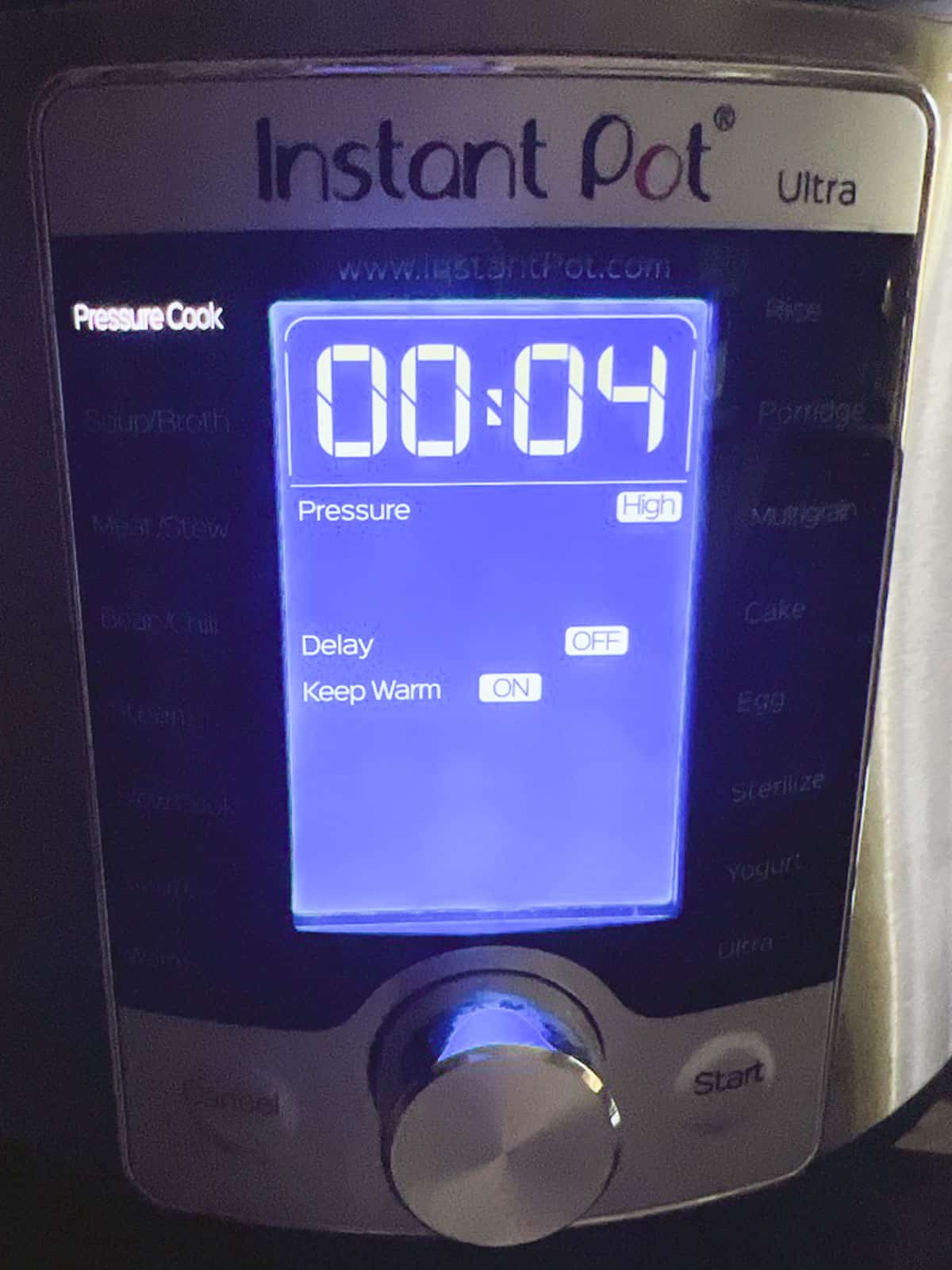 display panel of instant pot showing pressure cook setting for 4 minutes on high