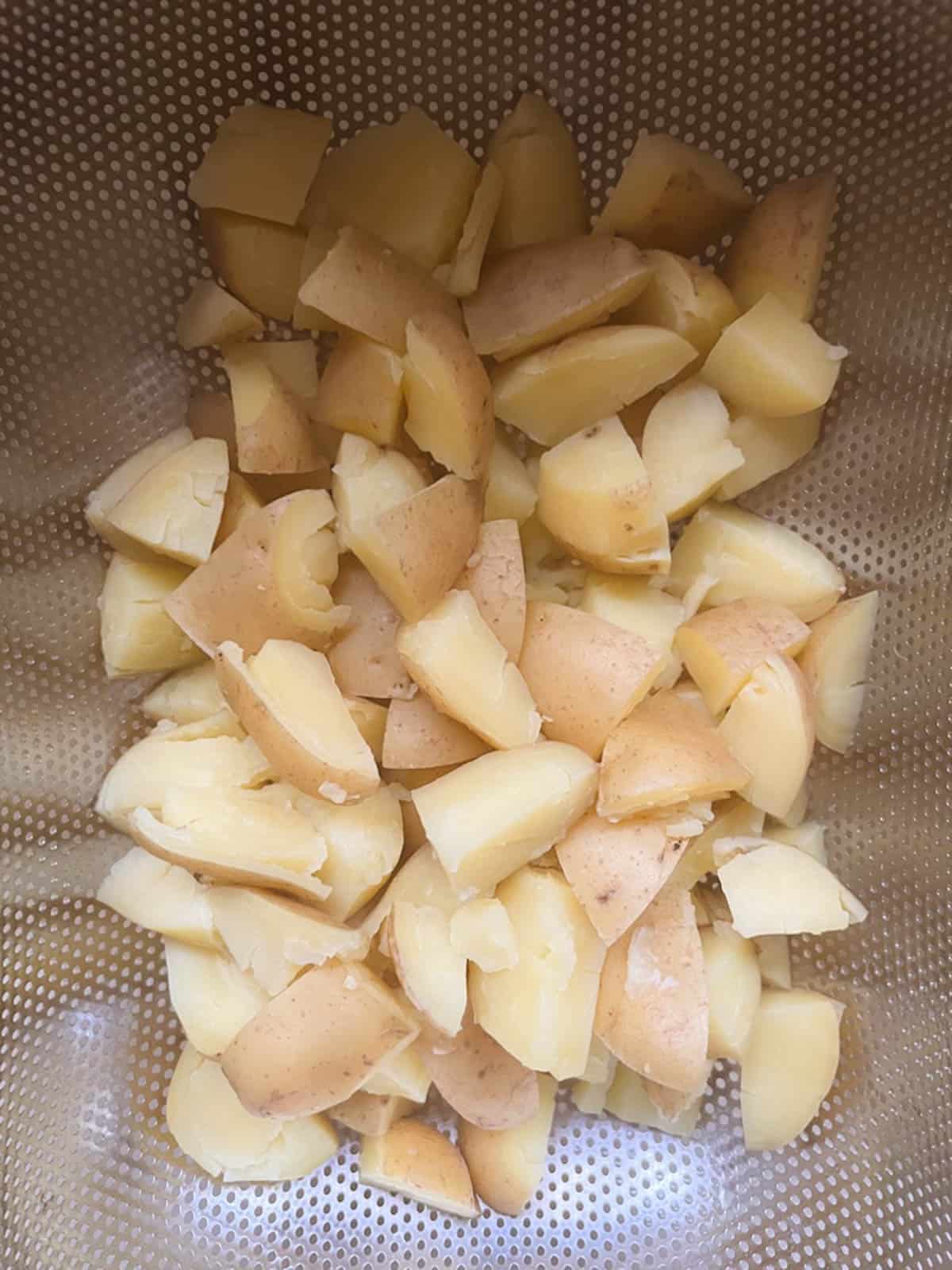 drained potato cubes in a colander