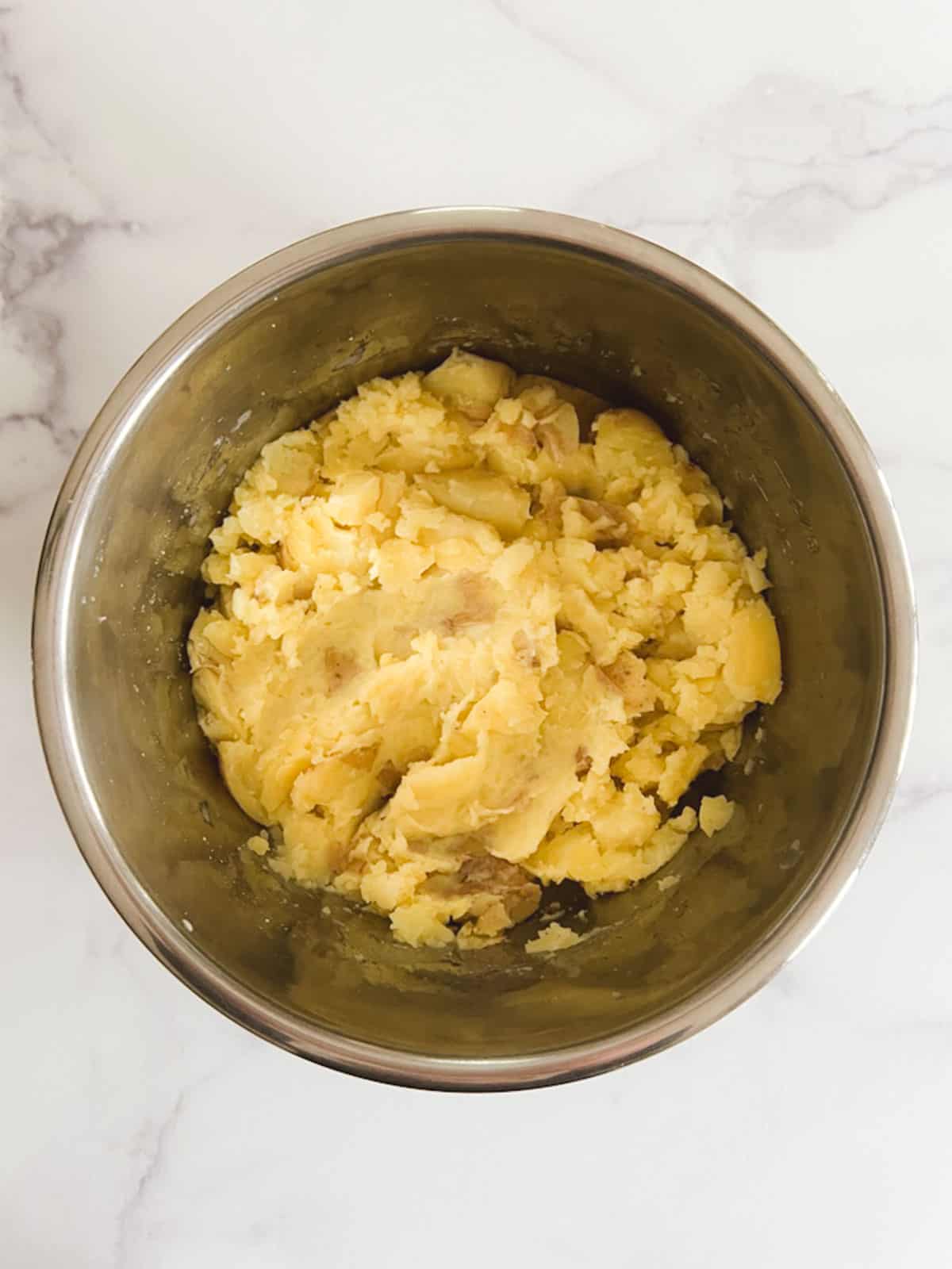 overhead view of potatoes mashed in inner pot