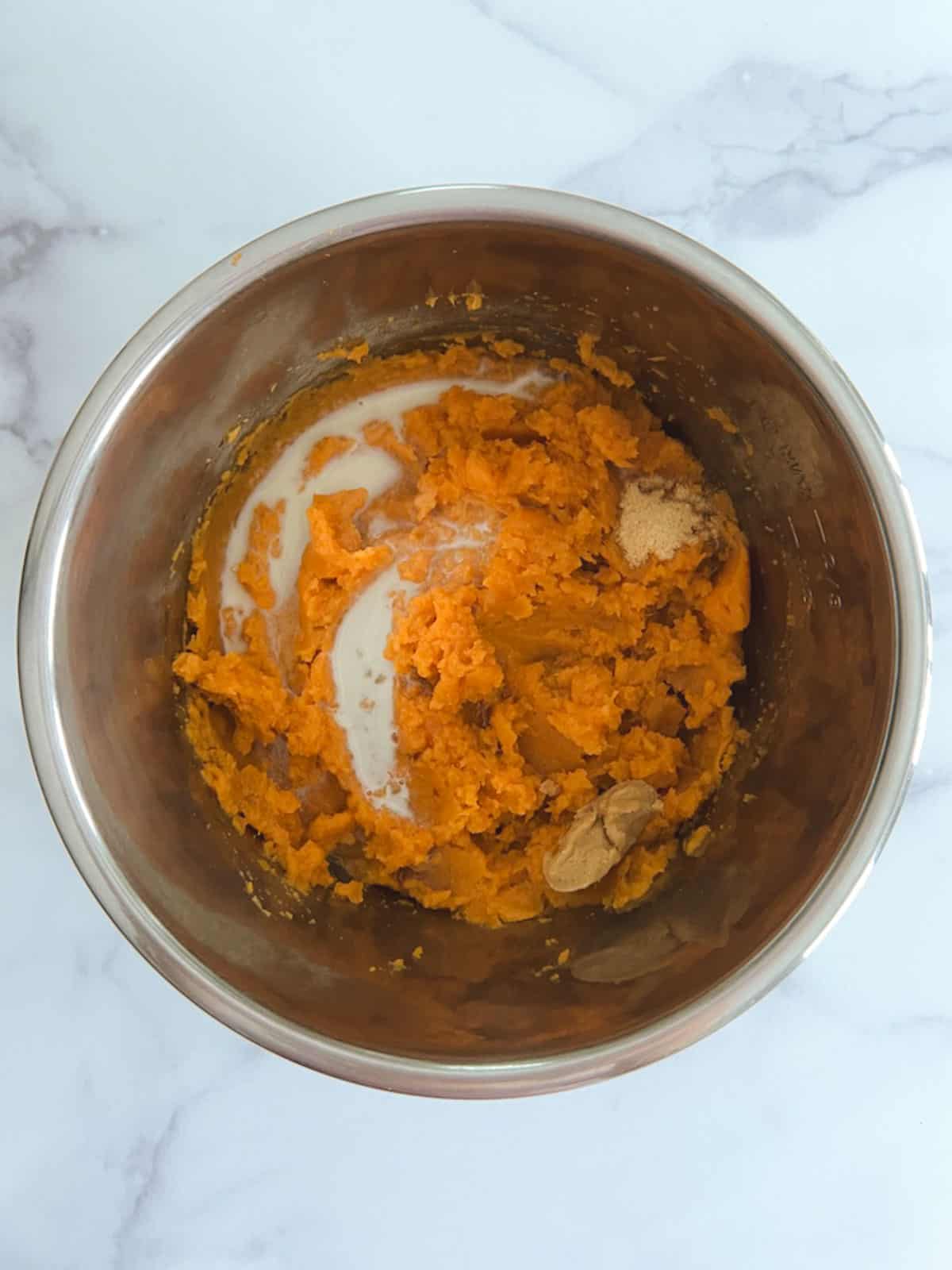 overhead view of inner pot containing mashed sweet potatoes and ingredients for miso-maple swirl