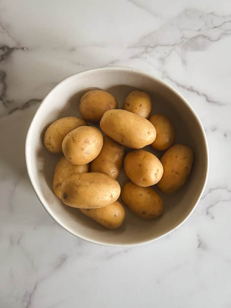 overhead view of bowl containing whole potatoes