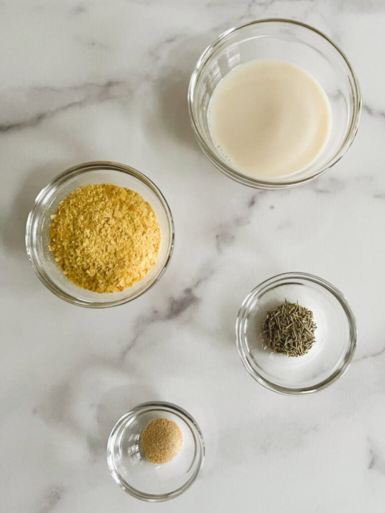 overhead view of plant milk and ingredients for cheesy rosemary option