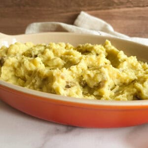 vegan instant pot mashed potatoes in a shallow orange serving dish