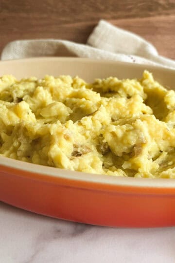 vegan instant pot mashed potatoes in a shallow orange serving dish