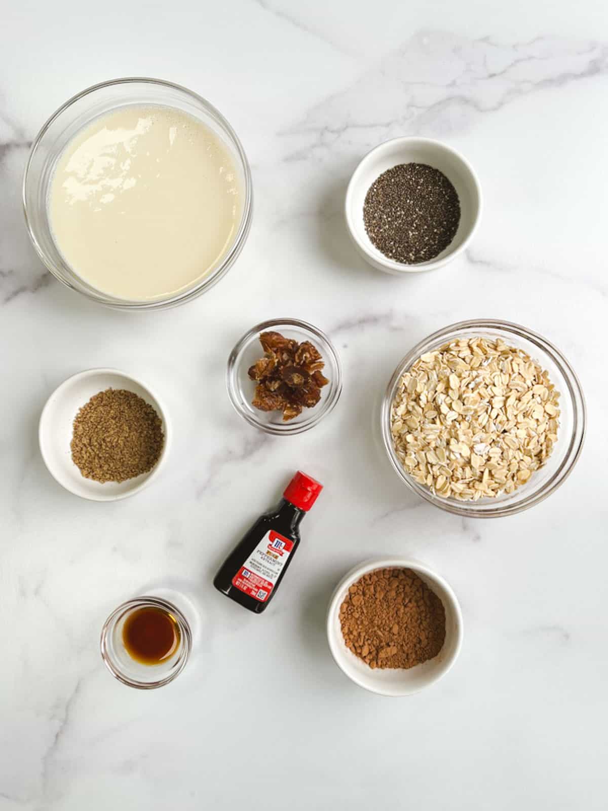 overhead view of bowls containing ingredients for mint chocolate overnight oats