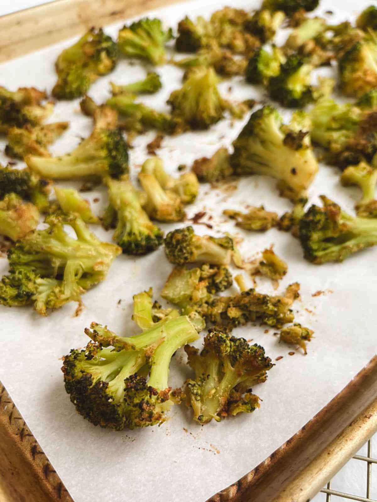 closeup of oil-free roasted broccoli on baking sheet