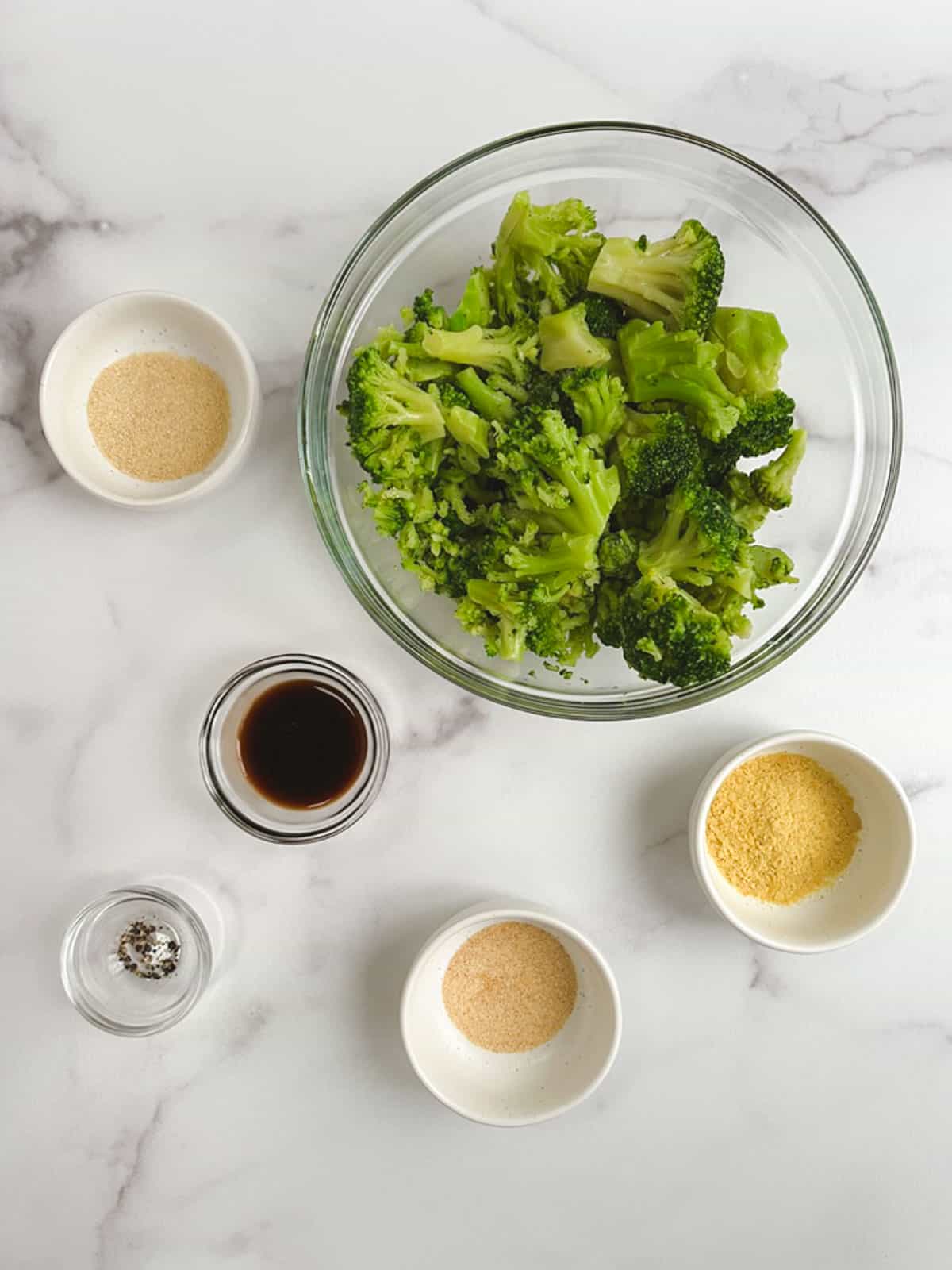 overhead view of bowls containing ingredients for oil-free roasted broccoli