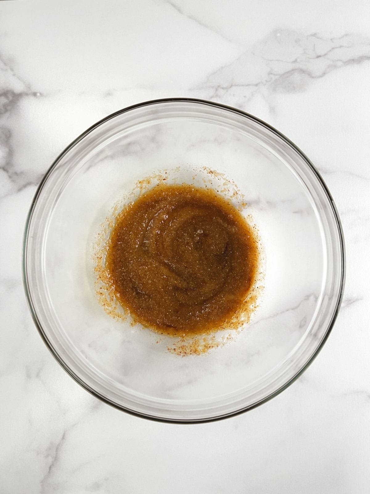 overhead view of glass bowl containing combined wet ingredients