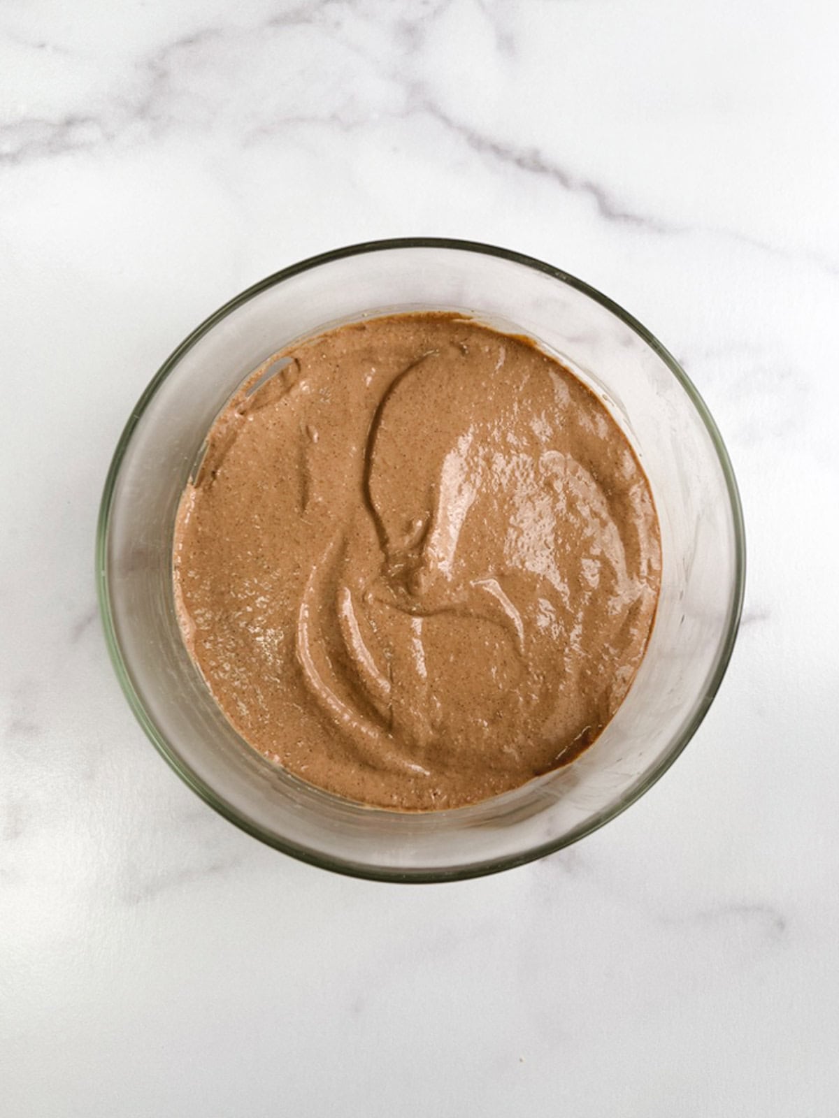 overhead view of glass bowl containing blended mint chocolate overnight oats