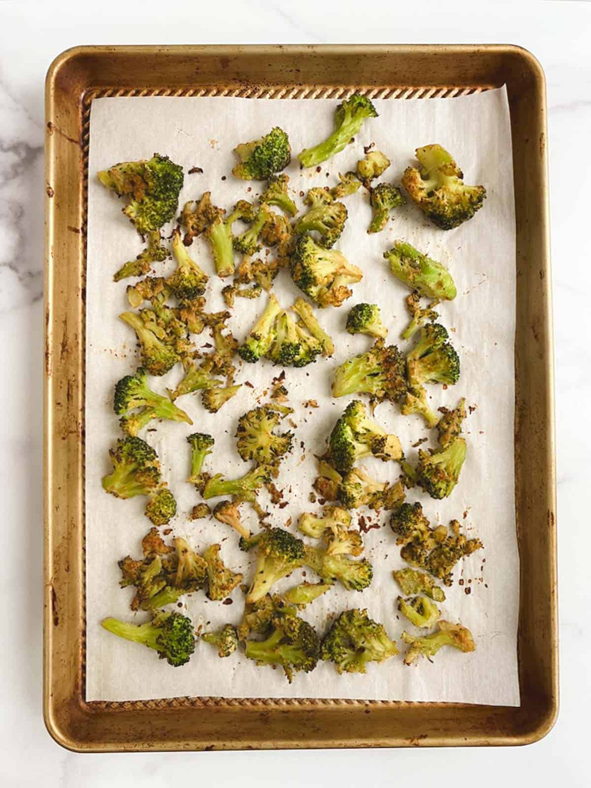 overhead view of prepared baking sheet containing oil-free roasted broccoli