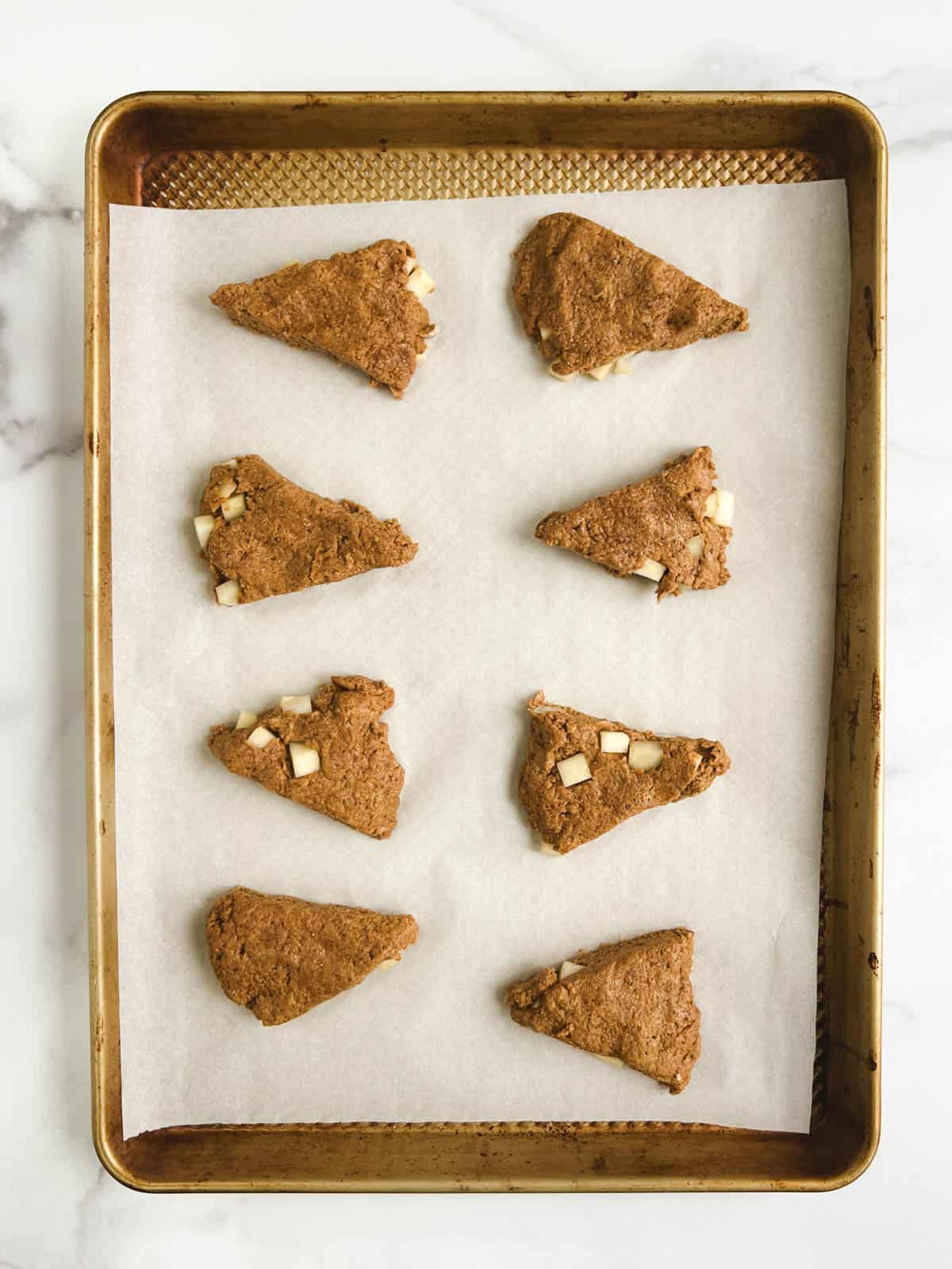 overhead view of prepared baking sheet containing 8 ginger pear scones