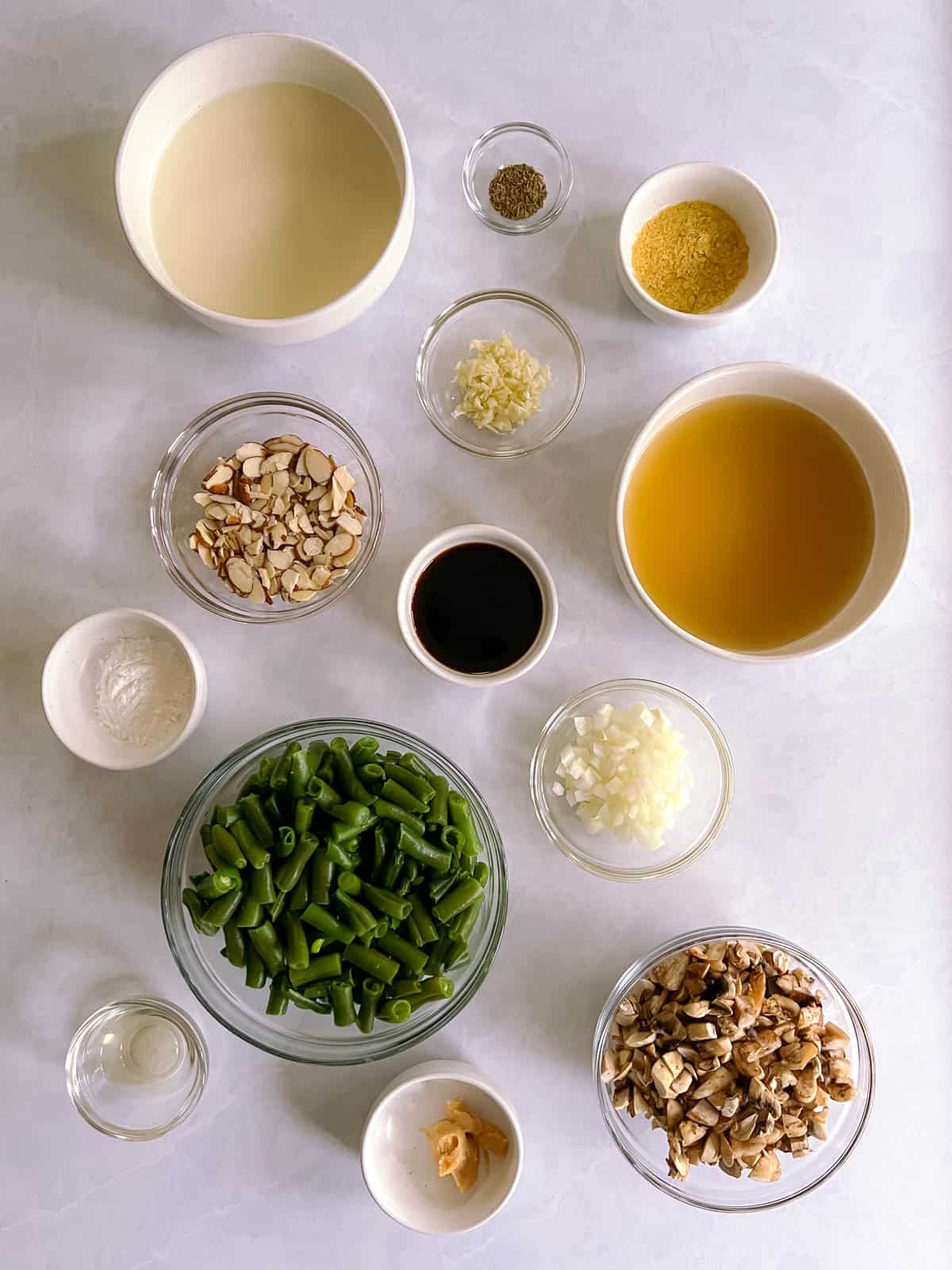 overhead view of bowls containing ingredients for vegan green bean casserole