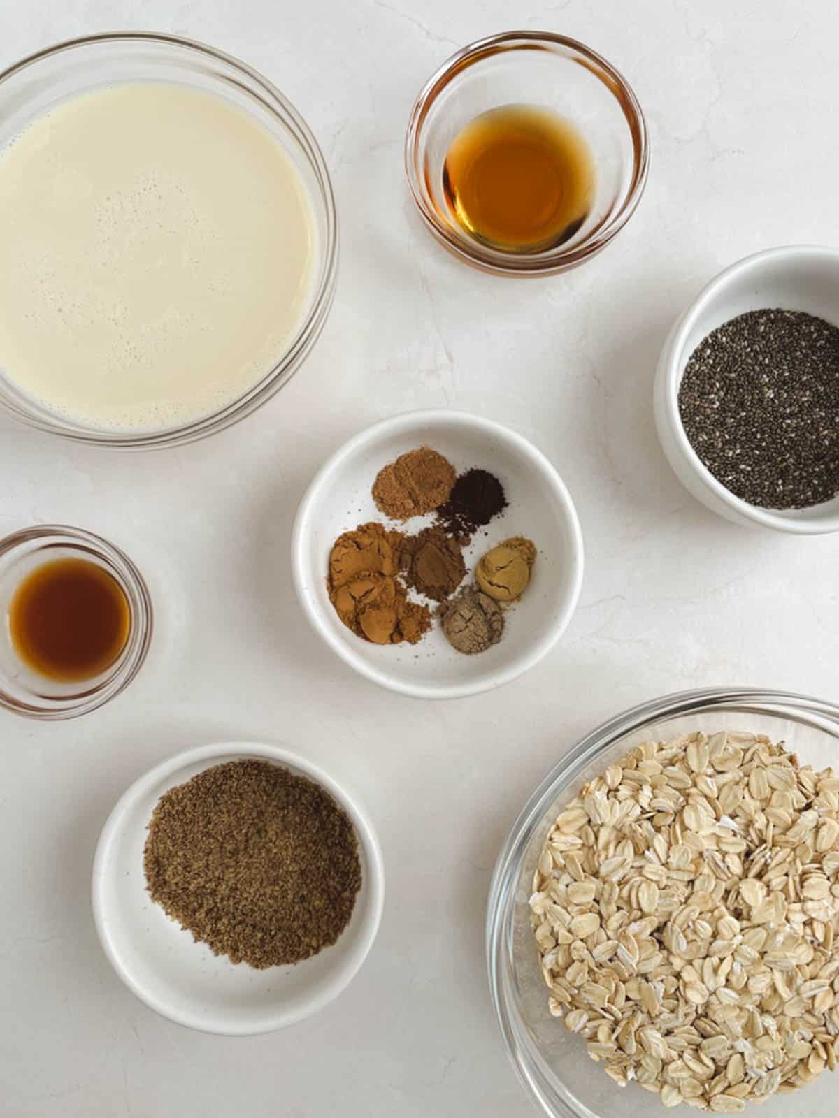 overhead view of bowls containing ingredients for chai overnight oats