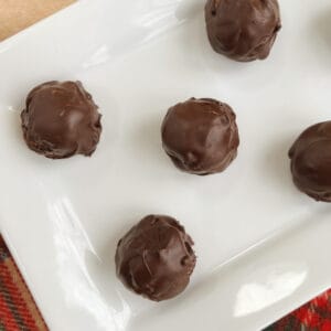 overhead of no bake chocolate peanut butter balls on a white rectangular serving dish